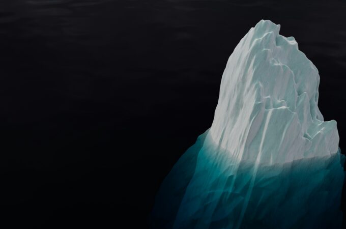 an iceberg in black water